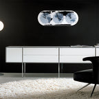 Modern living room with a white cabinet, black chair, and decorative wall light.