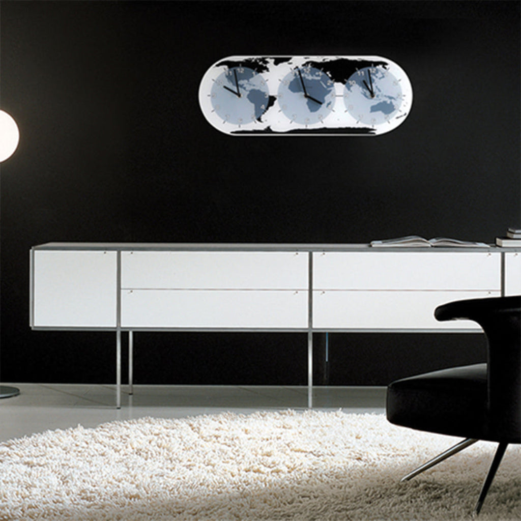 Modern living room with a white cabinet, black chair, and decorative wall light.