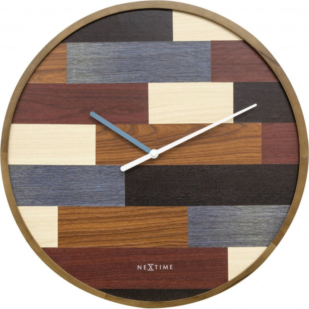 Wooden wall clock with a patchwork design and 'Nextime' branding. from Nextime available at Spacio retail stores in Mumbaii & Kolkata and online.