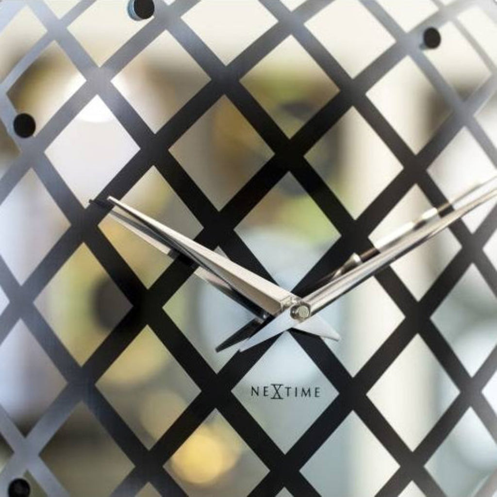 Decorative wall clock with lattice design on a white background