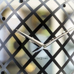 Decorative wall clock with lattice design on a white background