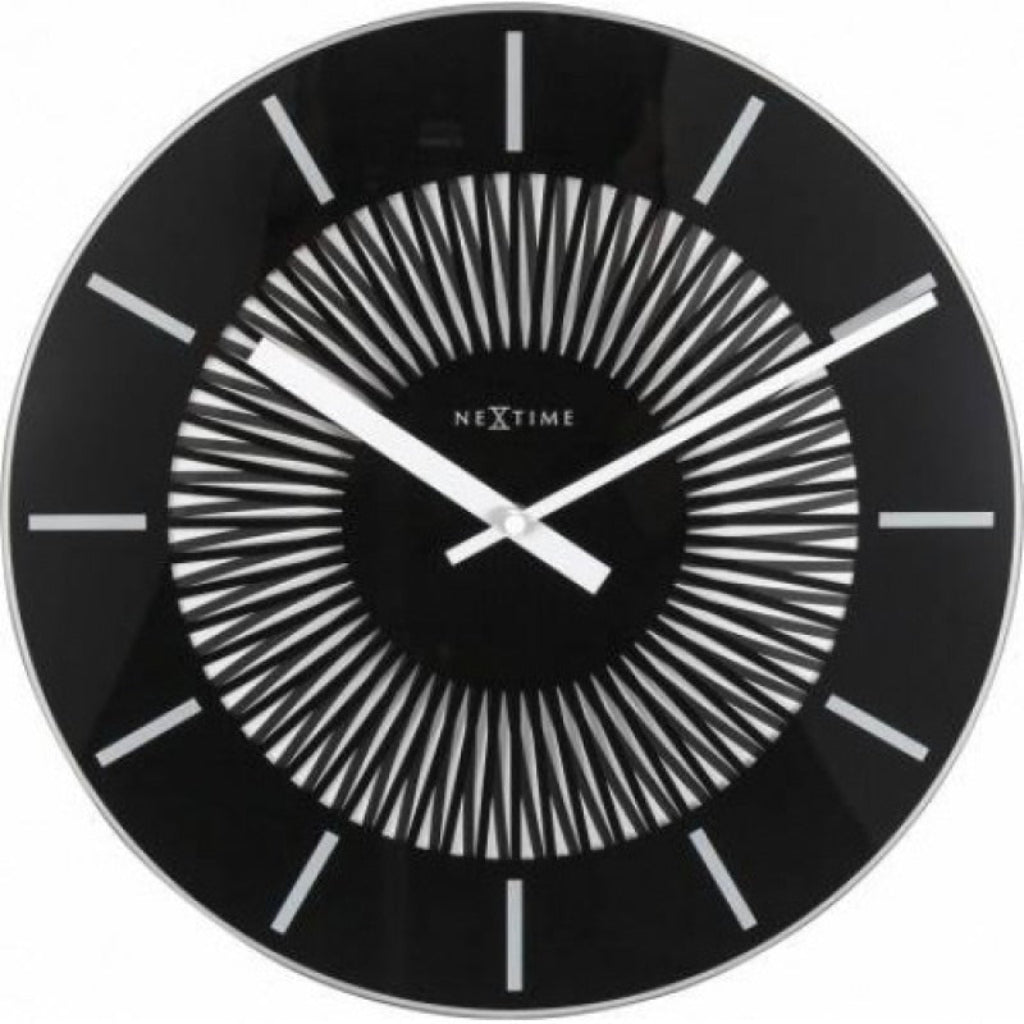 Black wall clock with white hands and 'NeXtime' branding on a white background from Nextime available at Spacio retail stores in Mumbaii & Kolkata and online.