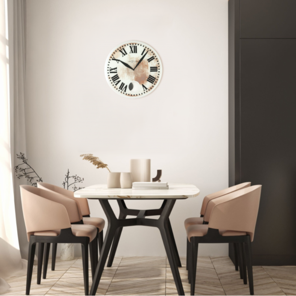 Dining room with a round table and chairs, featuring a decorative wall clock.