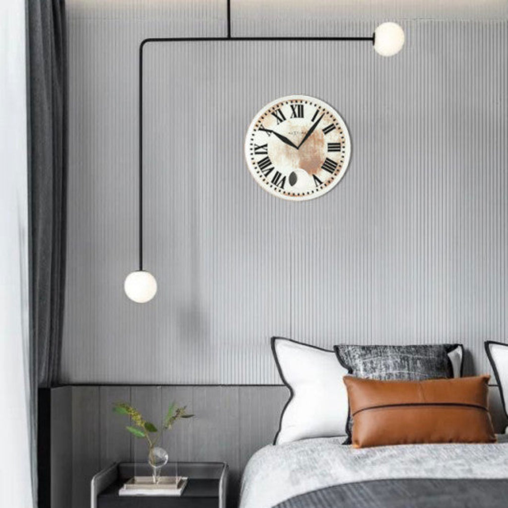 Modern bedroom with a bed, nightstand, and wall clock.