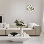 Modern living room with a beige sofa, white coffee table, and decorative items.