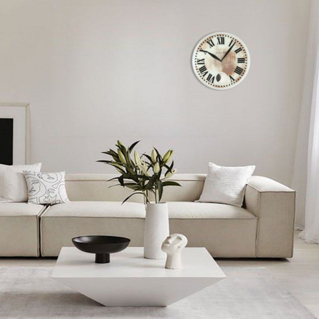 Modern living room with a beige sofa, white coffee table, and decorative items.