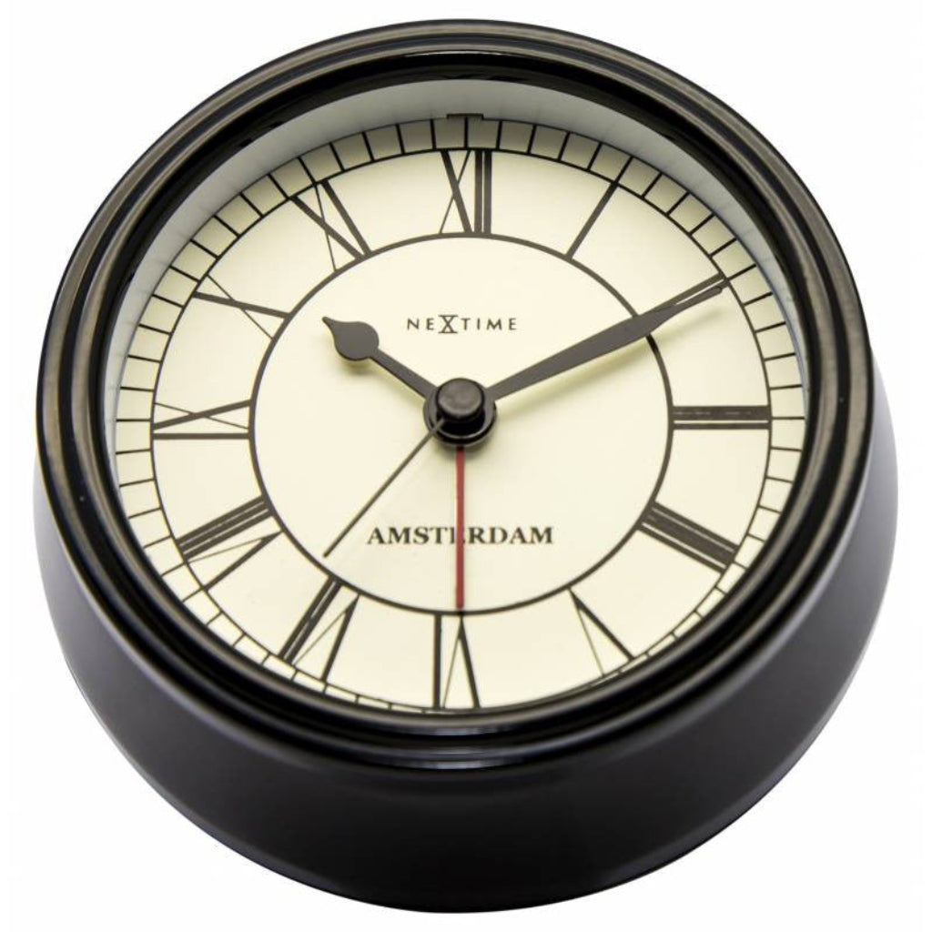 Round clock with black frame and white face displaying 'Nextime Amsterdam'. from Nextime available at Spacio retail stores in Mumbaii & Kolkata and online.