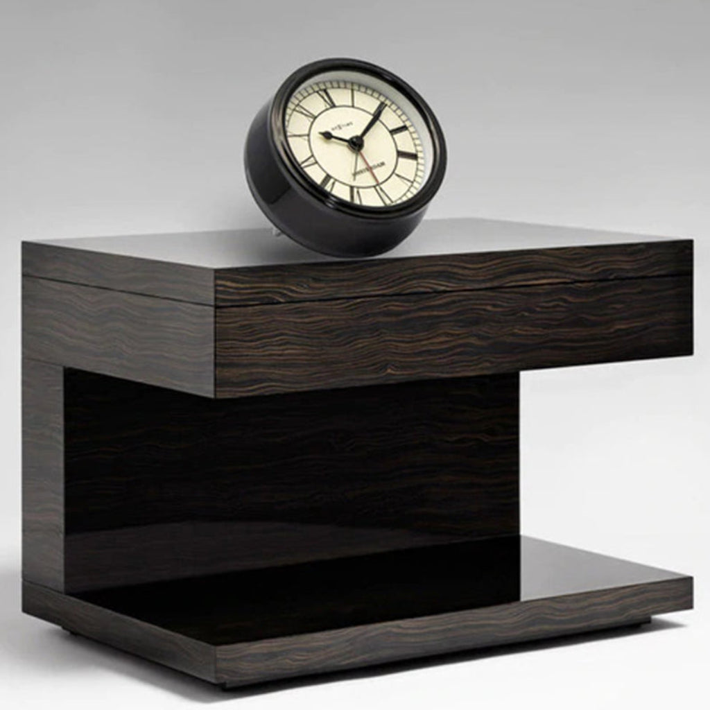 Modern dark wood side table with a clock on top against a gray background