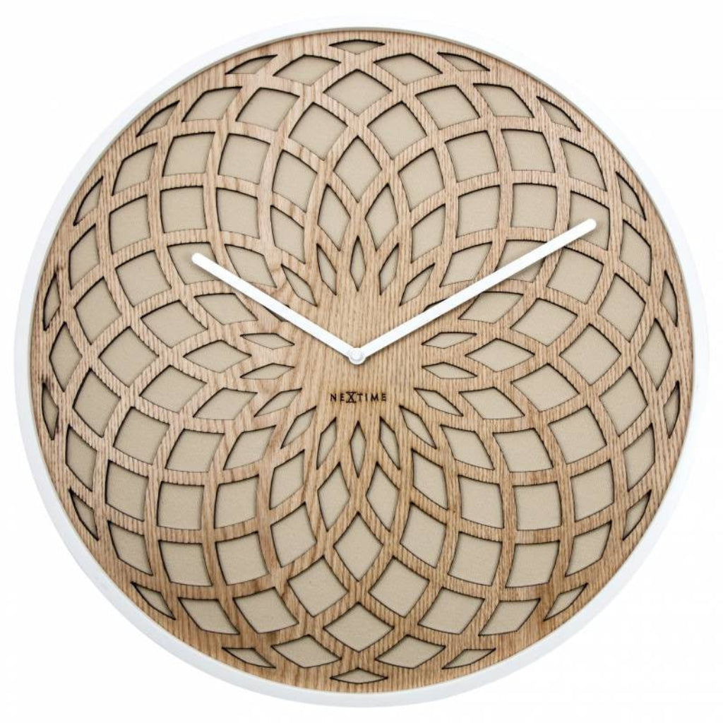 Wooden wall clock with intricate design and white hands on a white background from nextime available at Spacio retail stores in Mumbaii & Kolkata and online.