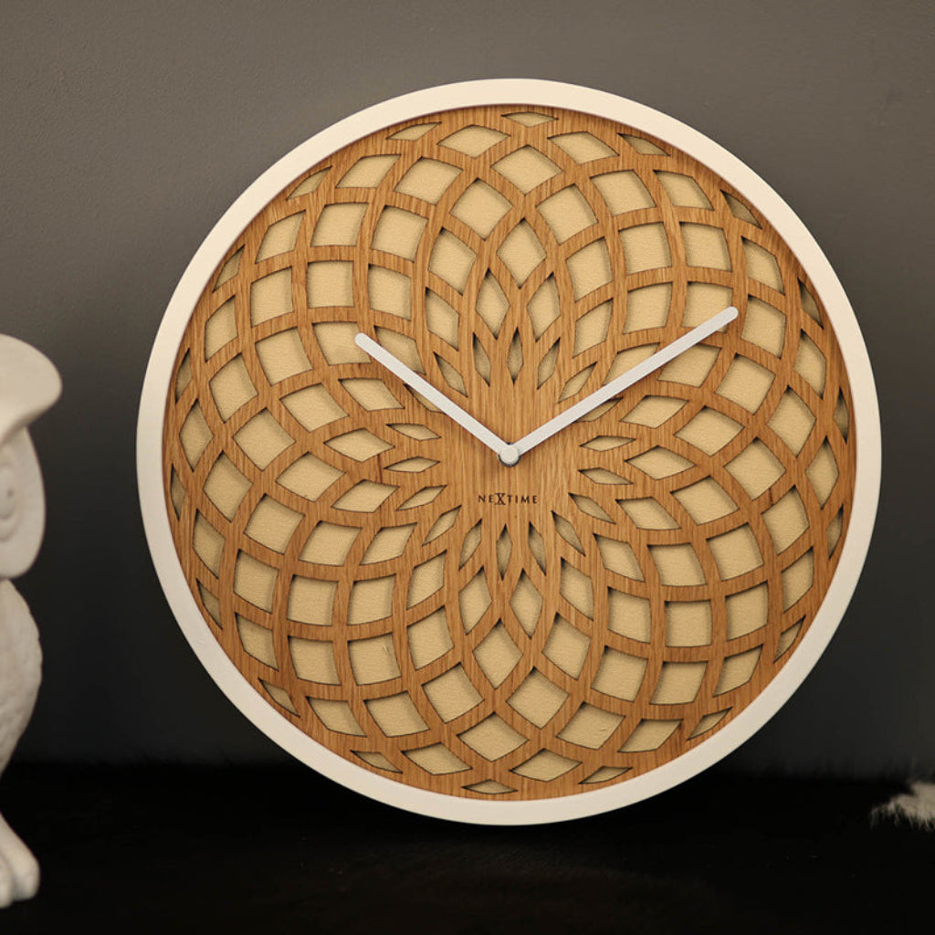 Wooden wall clock with intricate design on a dark background