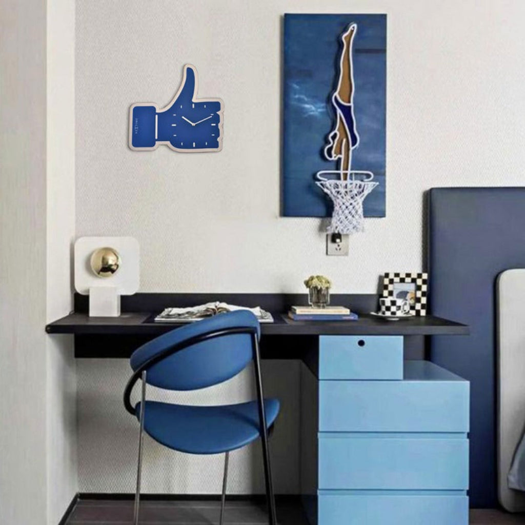 Modern room interior with blue desk, chair, and decorative items.