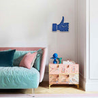 Modern bedroom with a pink bed, decorative cabinet, and blue wall clock.