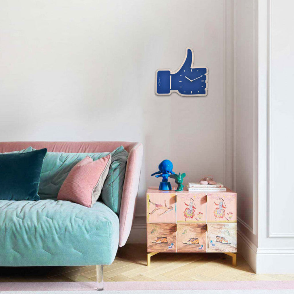 Modern bedroom with a pink bed, decorative cabinet, and blue wall clock.