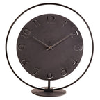 Decorative clock with black metal design on a white background from Nextime available at Spacio retail stores in Mumbaii & Kolkata and online.