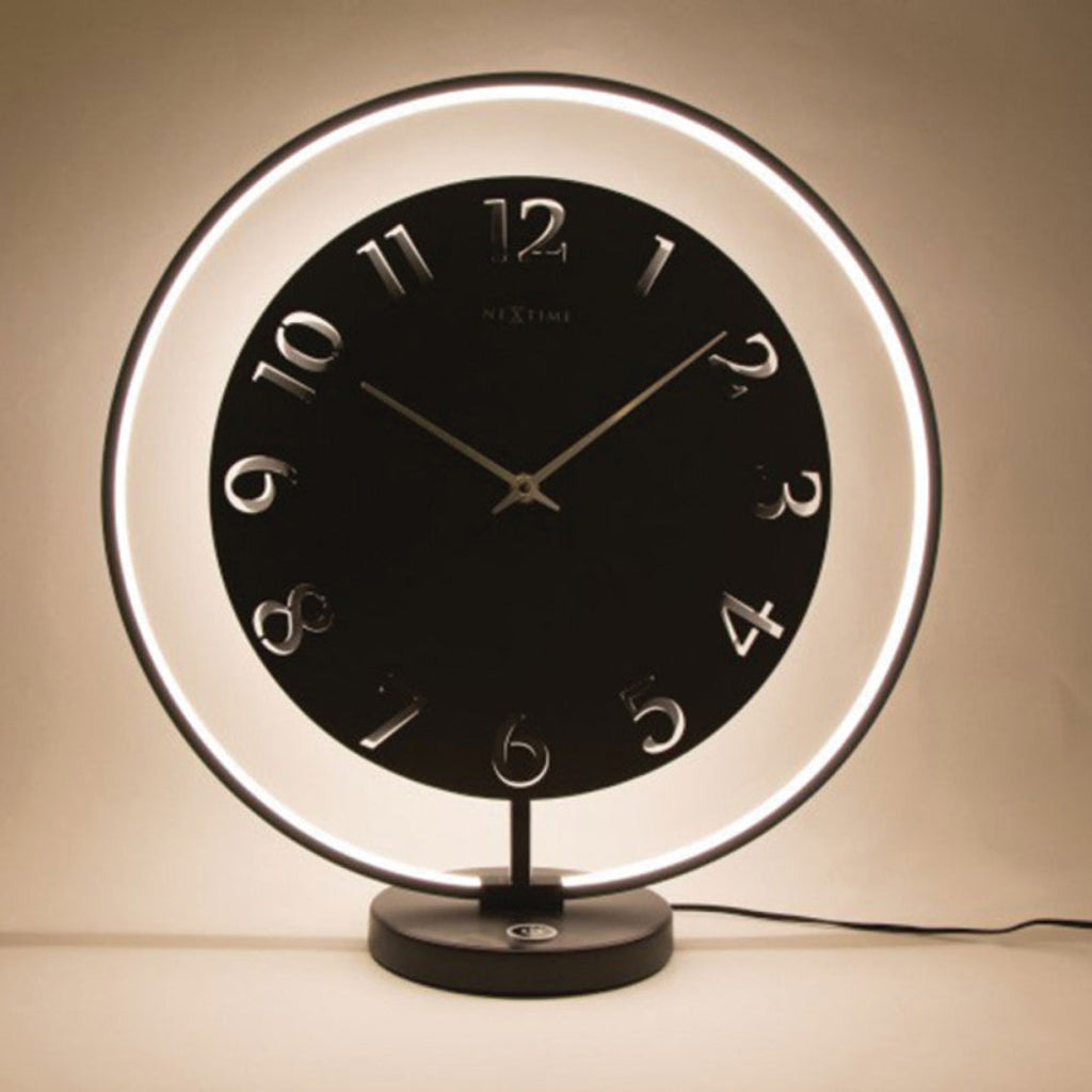 Table clock with illuminated rim on a beige background