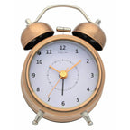 Bronze twin bell alarm clock with white face on a white background from Nextime available at Spacio retail stores in Mumbaii & Kolkata and online.