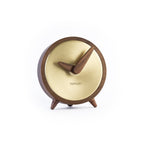 A Nomon wooden clock with a walnut stand on a white background. available at Spacio retail stores in Mumbaii & Kolkata and online.