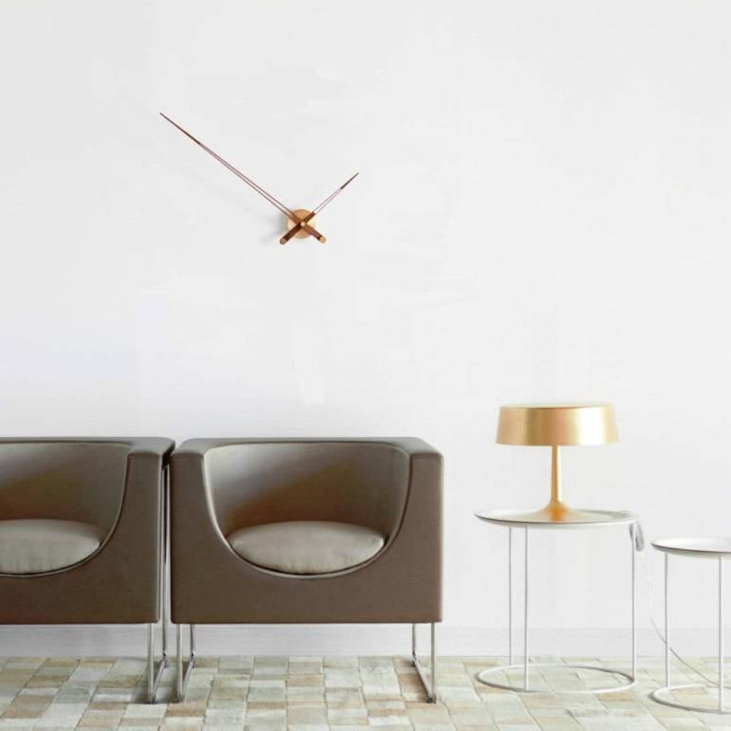 Modern interior with a chair, side table, and decorative clock on a white wall.