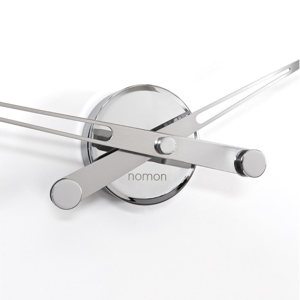 Modern wall clock with 'nomon' branding on a white background