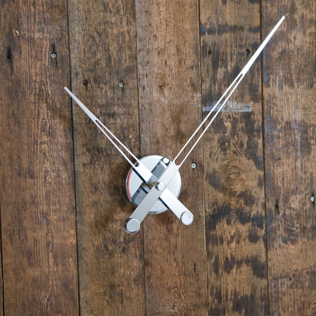 White clock hands on a wooden surface