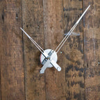 White clock hands on a wooden surface