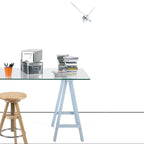 Glass table with books, a box, and a wooden stool on a white background