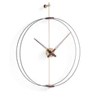 A Clock Nomon Barcelona Mini Gold MBARG by Nomon with a circular shape hanging on a wall. available at Spacio retail stores in Mumbaii & Kolkata and online.