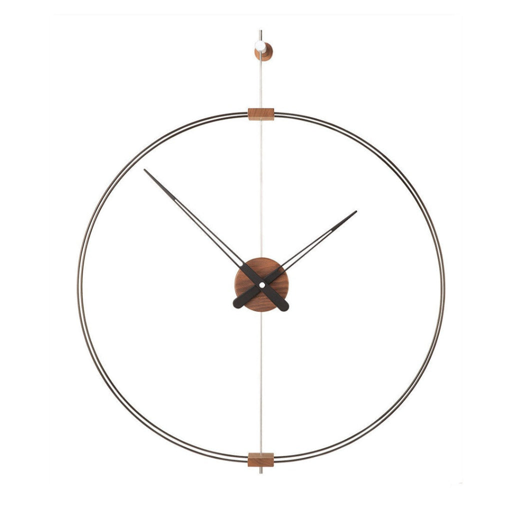 A Nomon Barcelona Mini MBAR wall clock with a circular shape hanging on a wall, featuring an elegant and sophisticated design. available at Spacio retail stores in Mumbaii & Kolkata and online.