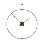 A Nomon Barcelona Mini MBAR wall clock with a circular shape hanging on a wall, featuring an elegant and sophisticated design. available at Spacio retail stores in Mumbaii & Kolkata and online.