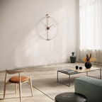 Modern living room with a wall clock, coffee table, and chair.