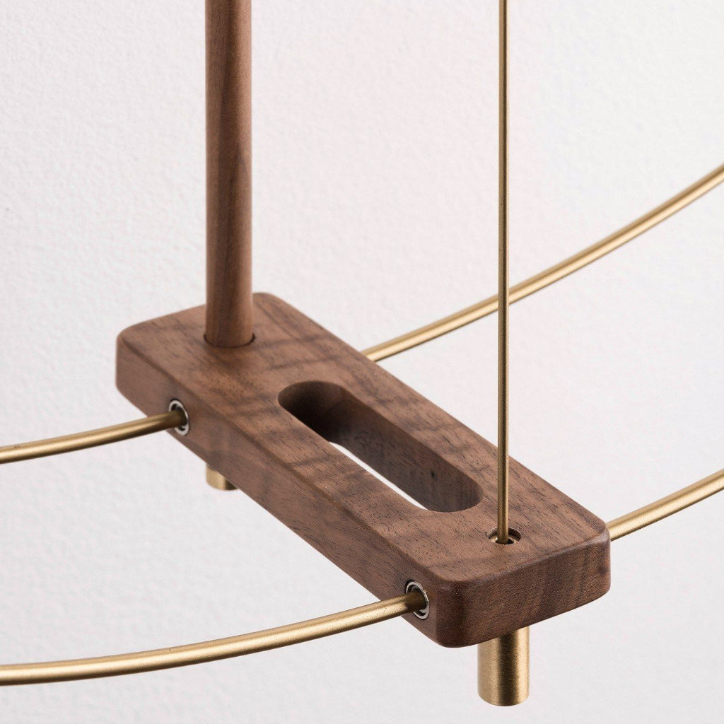 Wooden bracket with gold metal rods on a light gray background