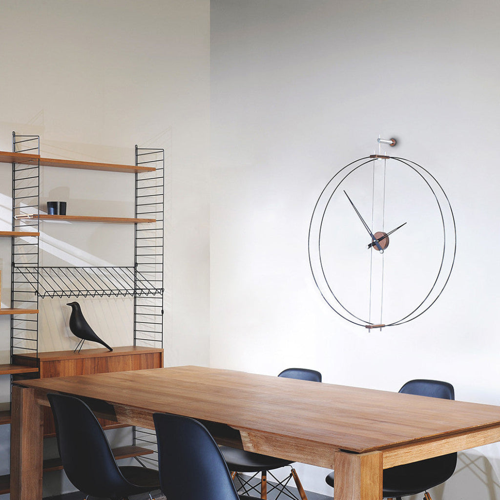 Modern dining room with wooden table, black chairs, and a large round wall clock.