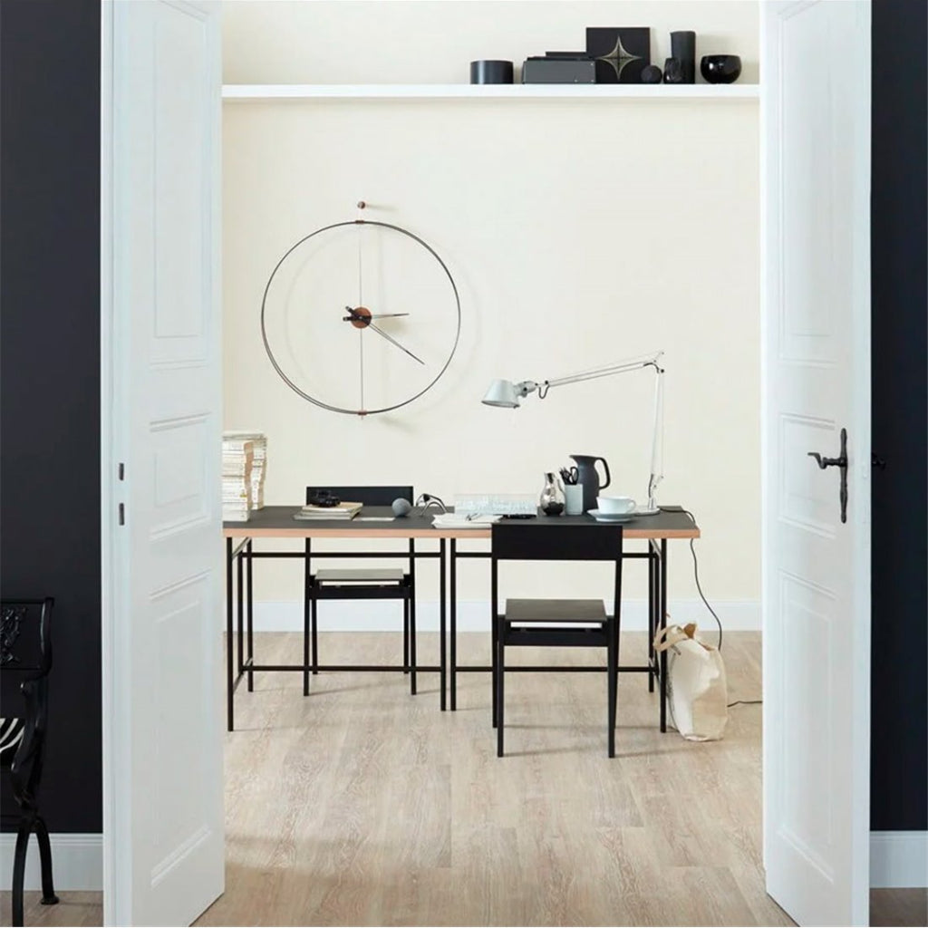 Modern office space with a desk, chairs, and decorative items.