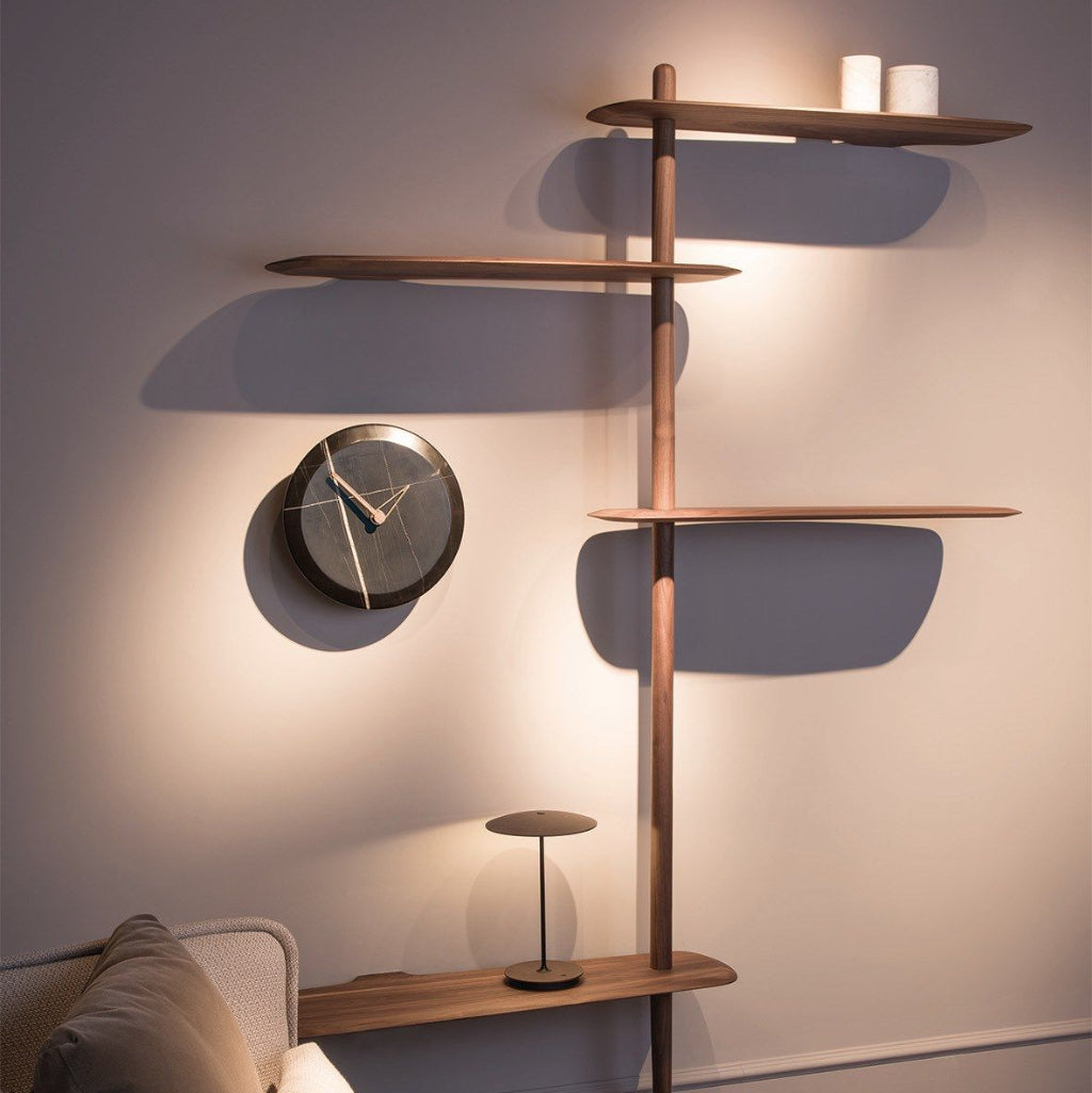 Modern wooden shelf with decorative items against a wall