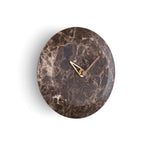 A Nomon Bari S Emperador HUGSE levitating marble clock on a white wall. available at Spacio retail stores in Mumbaii & Kolkata and online.