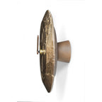 Decorative wall sconce with marble-like finish on a white background