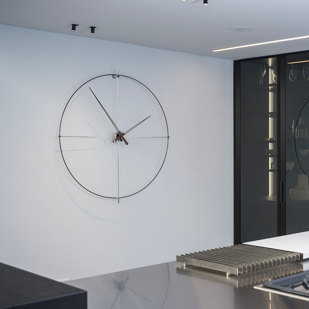 Modern wall clock on a white wall in a minimalistic interior setting.