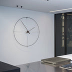 Modern wall clock on a white wall in a minimalistic interior setting.