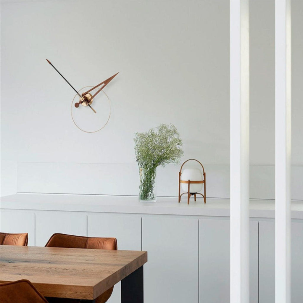 Modern interior with a wooden table, chairs, and decorative elements on a light gray wall.