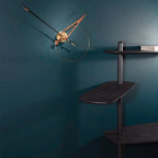 Modern wall clock with gold accents on a dark teal wall