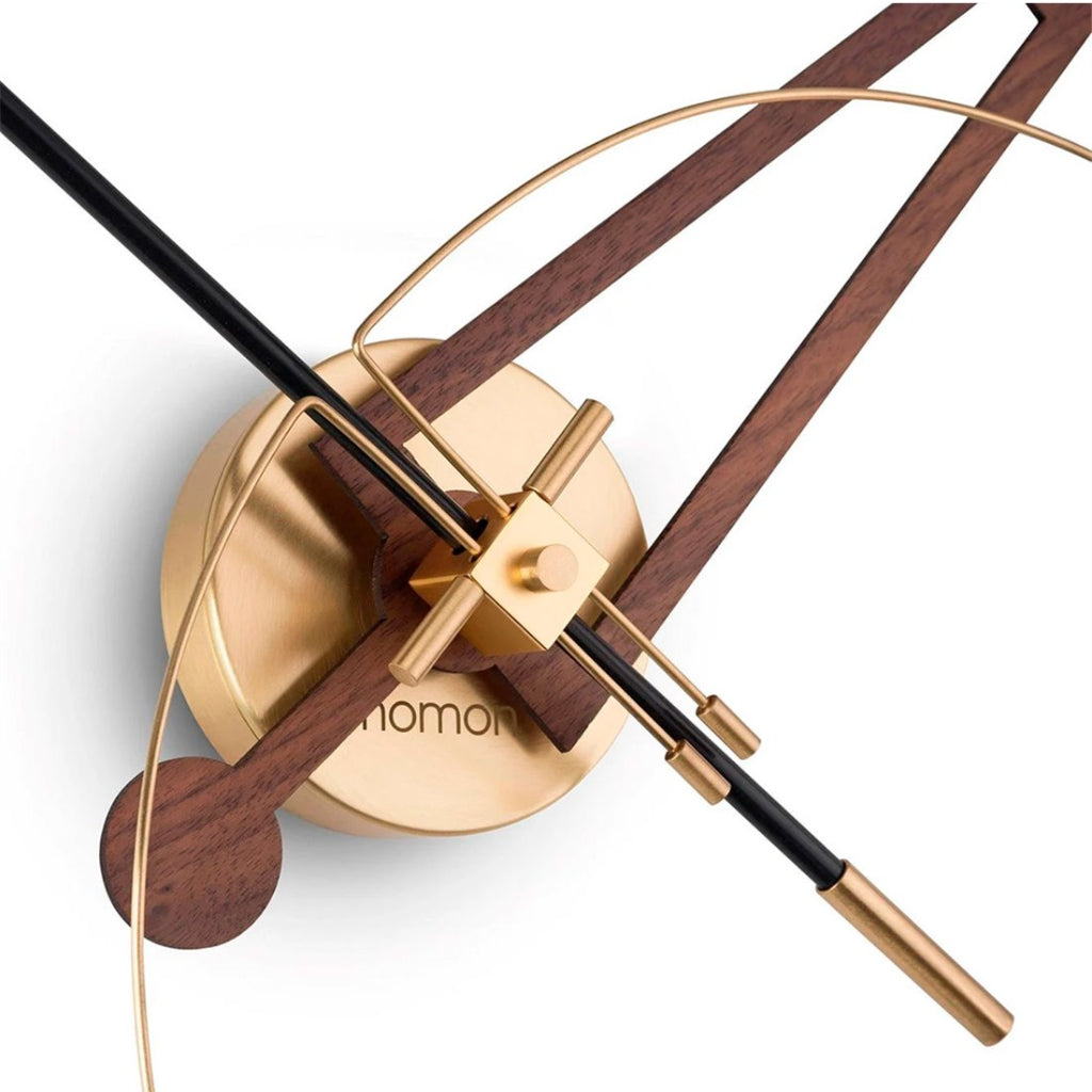 Decorative wall clock with gold and wooden design on a white background