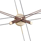 Modern wall clock with wooden and brass accents on a white background