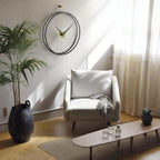 Modern living room with a white armchair, coffee table, and decorative items.