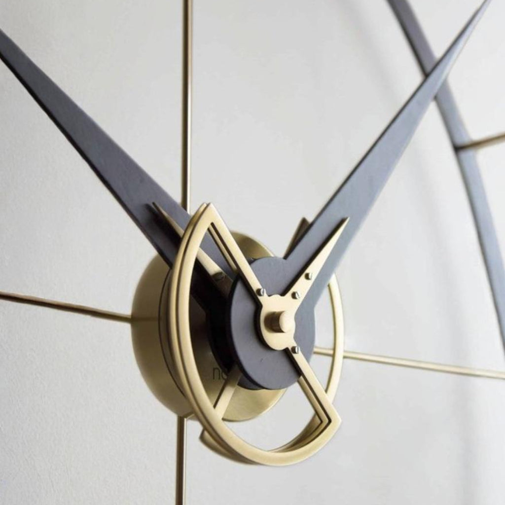 Close-up of a clock with gold and black design on a light gray background