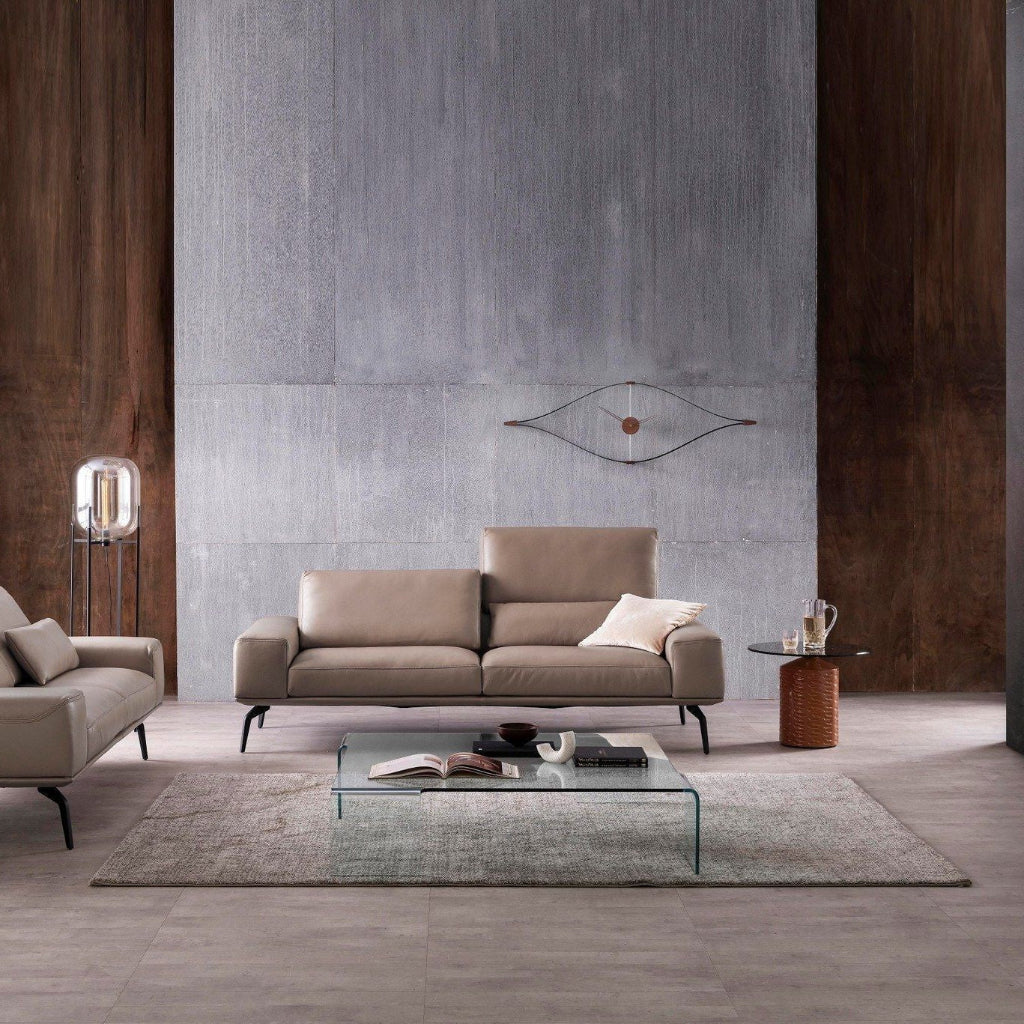 Modern living room with a beige sofa, coffee table, and decorative items.