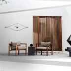 Two wooden chairs with cushions in a modern interior setting.