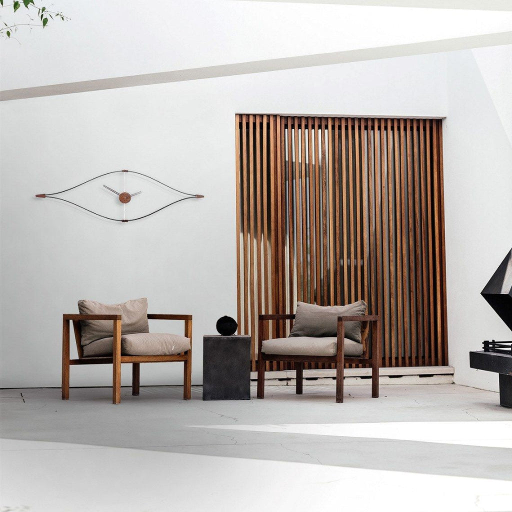 Two wooden chairs with cushions in a modern interior setting.