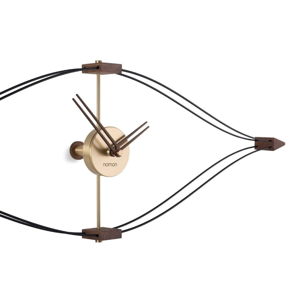 Modern wall clock with gold and bronze design on a white background