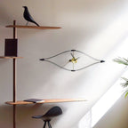 Modern interior with wooden shelves, a bird figurine, and a wall clock.