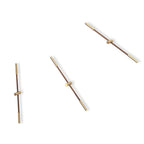 Three wall-mounted clock designs with gold and bronze accents on a white background